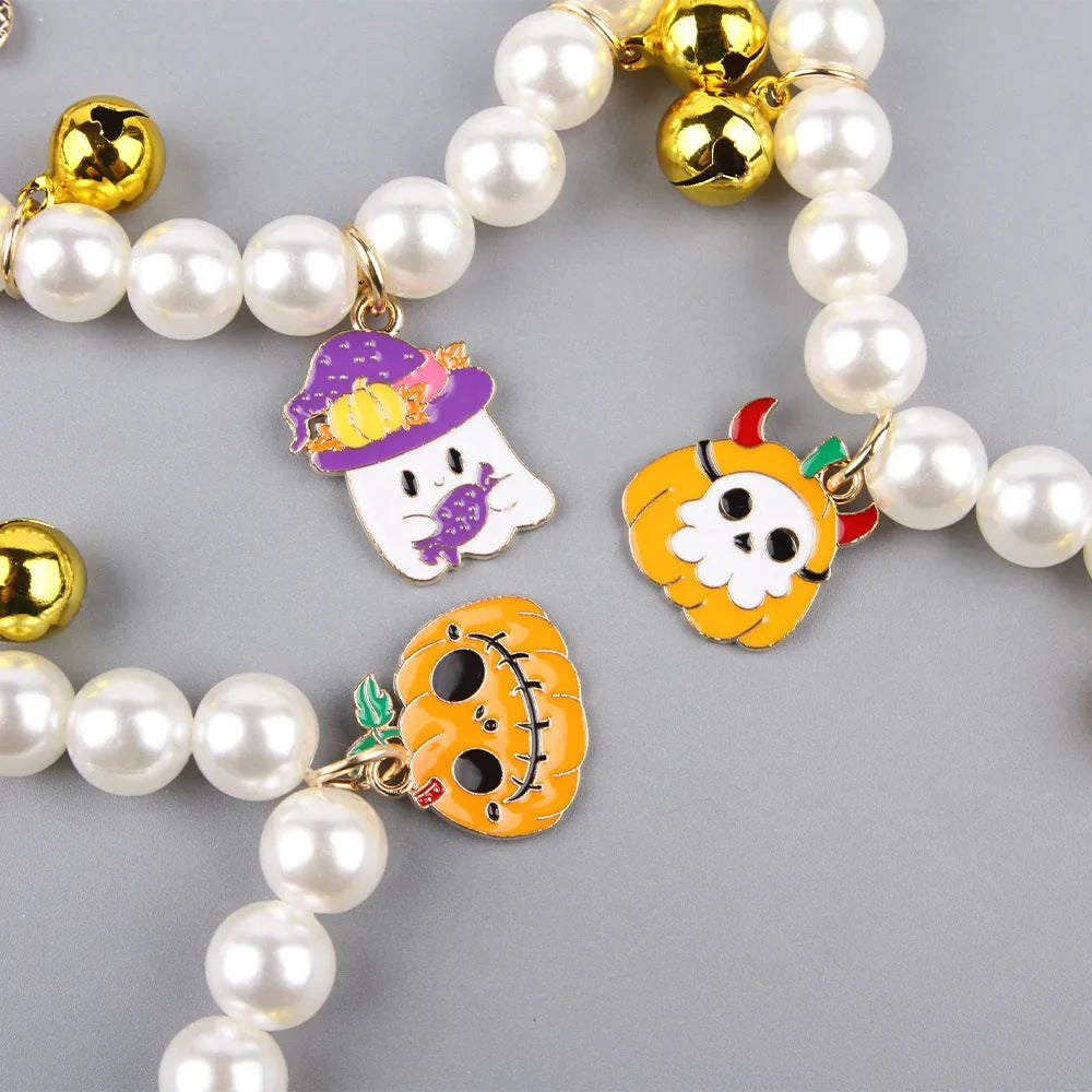 Simulated pearl Halloween cat collar with a choice of purple ghost, skull, or smiling pumpkin charm.