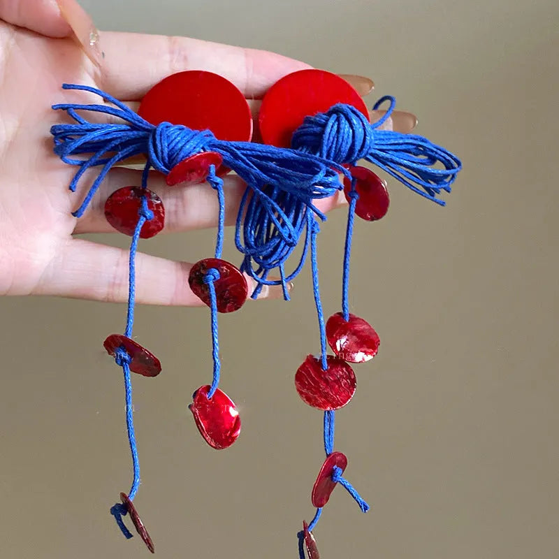 Handcrafted geometric cloth earrings with blue resin flower and silver needle detailing