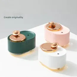Green rotating planet-shaped USB humidifier with night light on a wooden surface