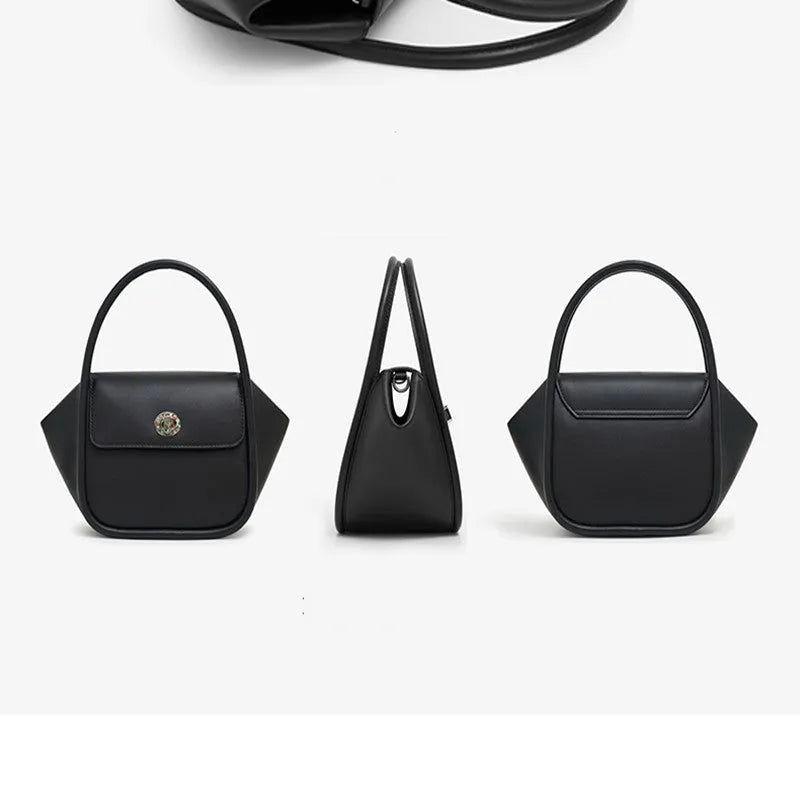 Women's wing-shaped leather tote bag with a latch buckle, shown in Atlantic blue with a cross-body strap.