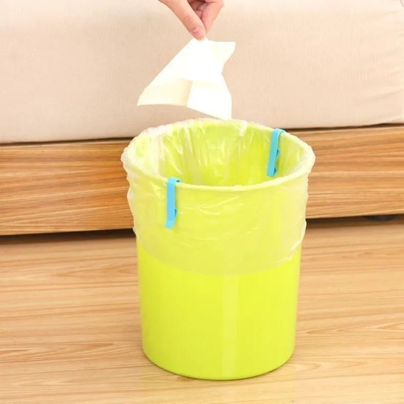 Green and black non-slip plastic clip for holding a bin bag on a wheelie bin rim.