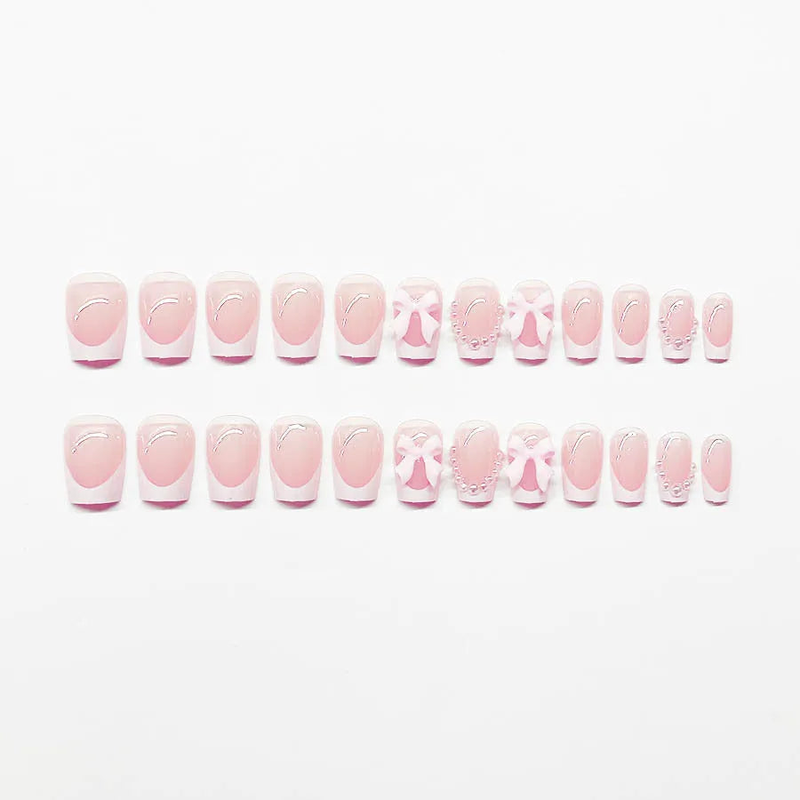 Short white French manicure press-on nails with bow, tulip, and starry sky decorative patterns