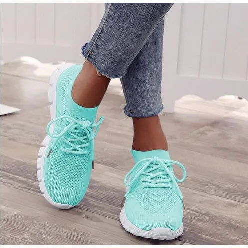 Women's breathable lace-up sneaker in a low-top style with a flat rubber sole.