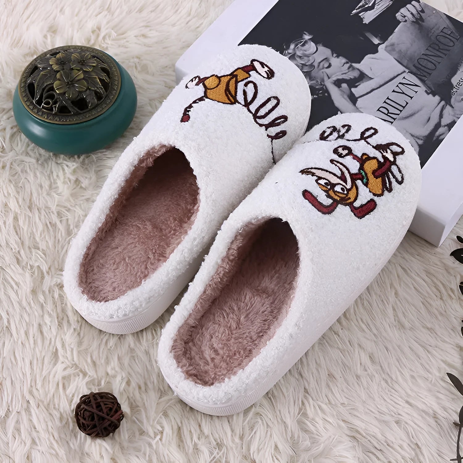 White fluffy slippers with cartoon pattern, rubber sole, and a toe holder design.