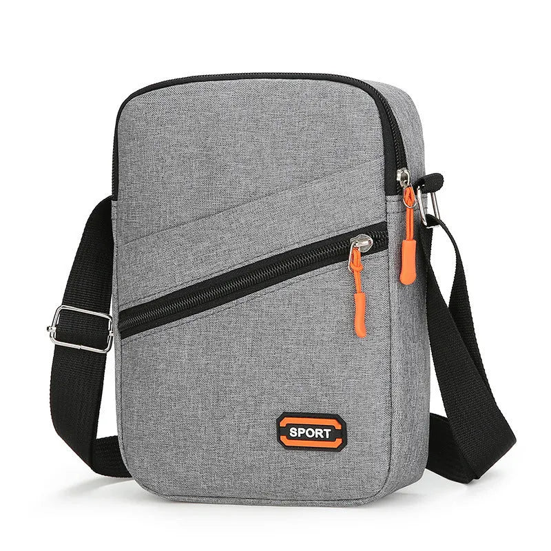 Solid colour Oxford cloth commuter bag with contrast detailing and crossbody shoulder strap