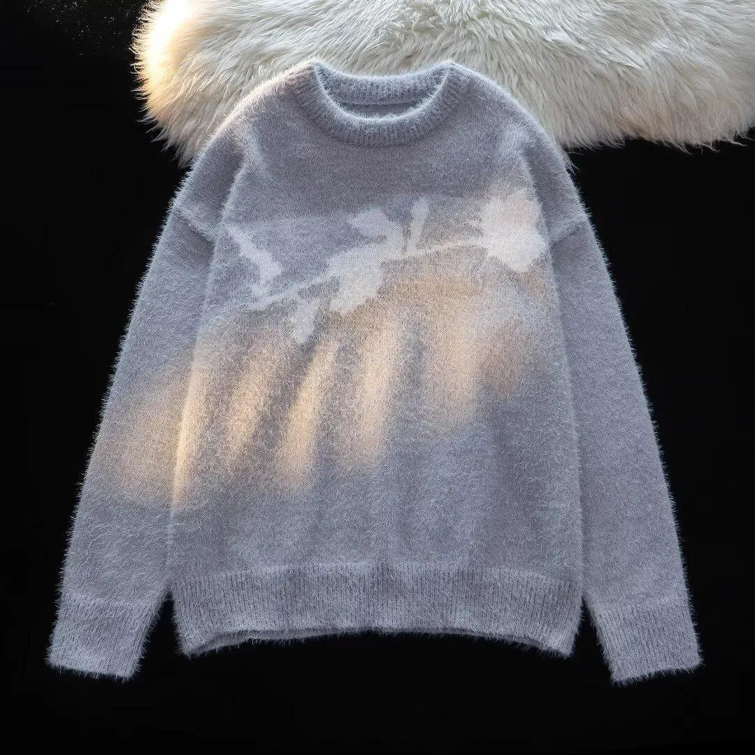 Man wearing a black cotton fleece sweater with a flocking horse and American Dark Rose pattern.