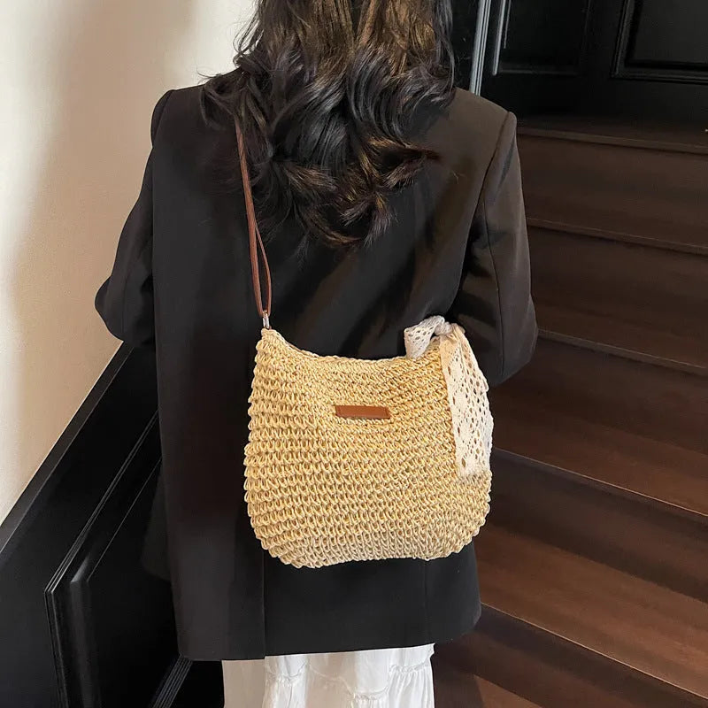 Women's woven straw messenger bag with hollowed pattern design in beige colour