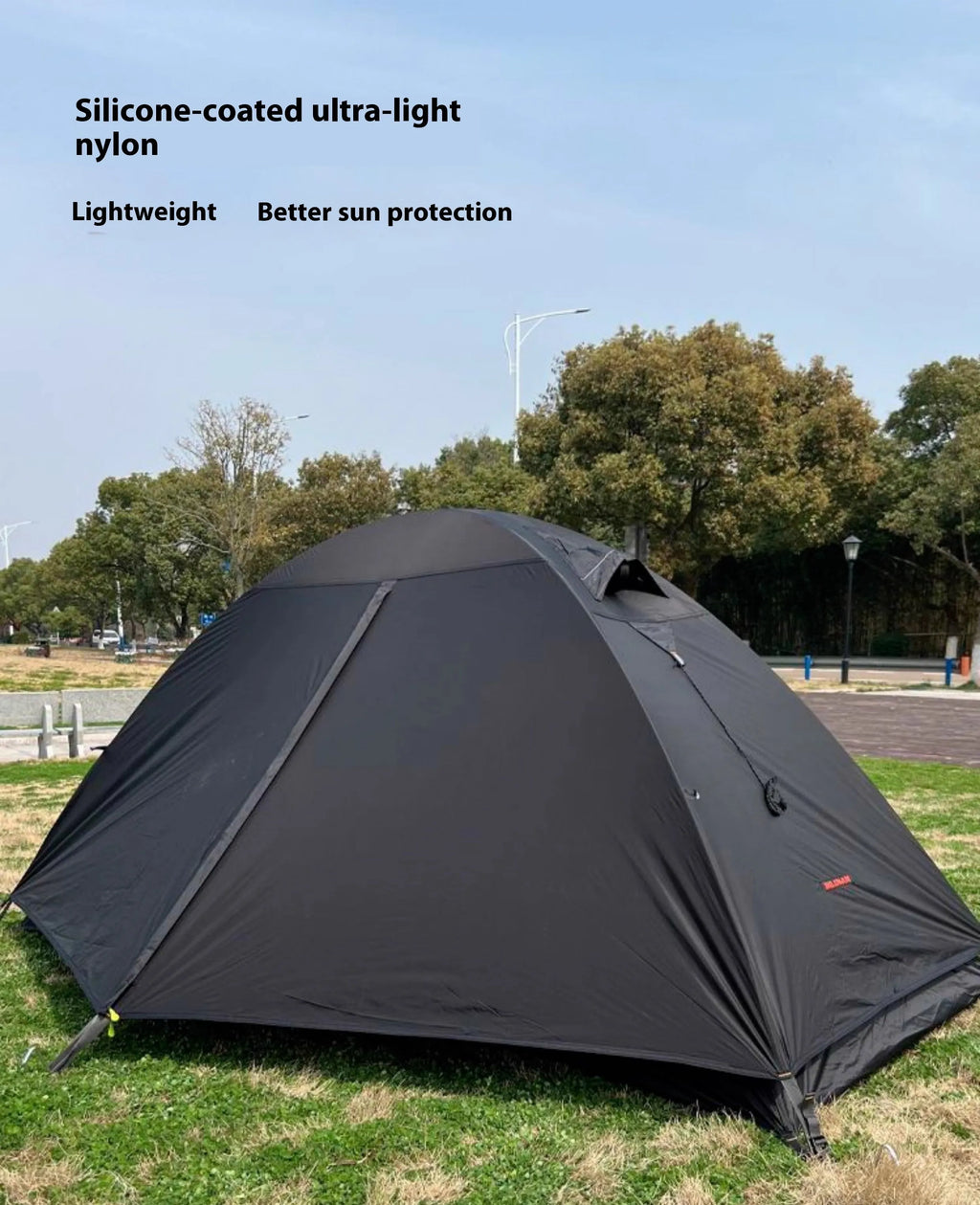Single person camping tent with aluminium poles shown in black colour with waterproof outer layer and mesh ventilation panels