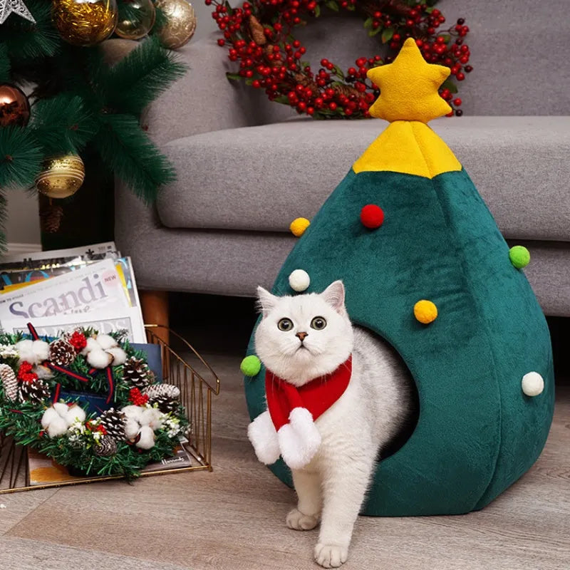 Red Christmas tree shaped plush cave bed for cats and small dogs on a wooden floor.
