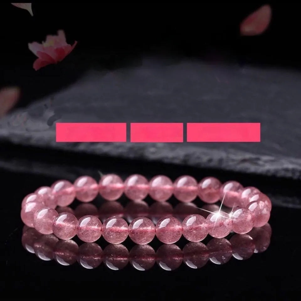 Women's strawberry quartz bracelet with polished beads in 6mm, 8mm, or 10mm sizes on adjustable knot.