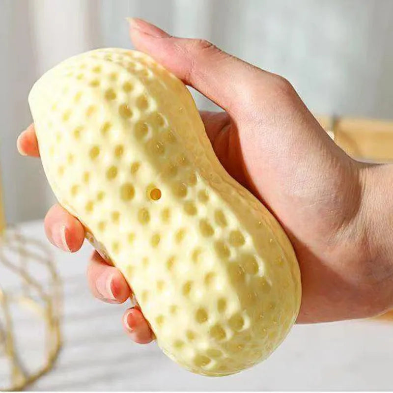 Yellow peanut-shaped dog chew toy with TPR rubber construction measuring 12x5.6cm