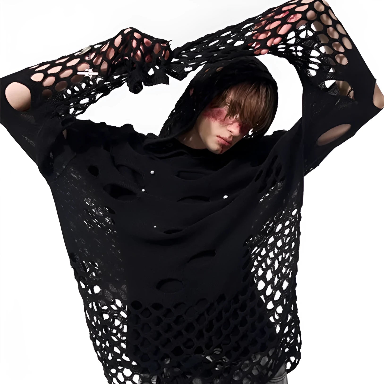 Man wearing a loose black hoodie with a pearl decoration on the front of the hood.