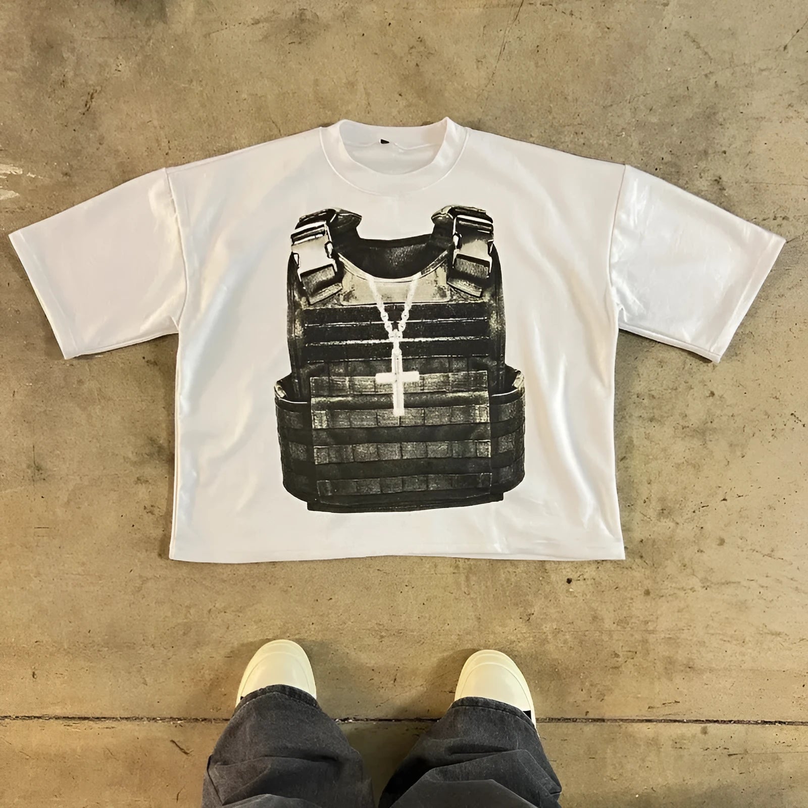 A person wearing a printed cotton short sleeve T-shirt with retro graphics and drop shoulder sleeves in a contrast colour.