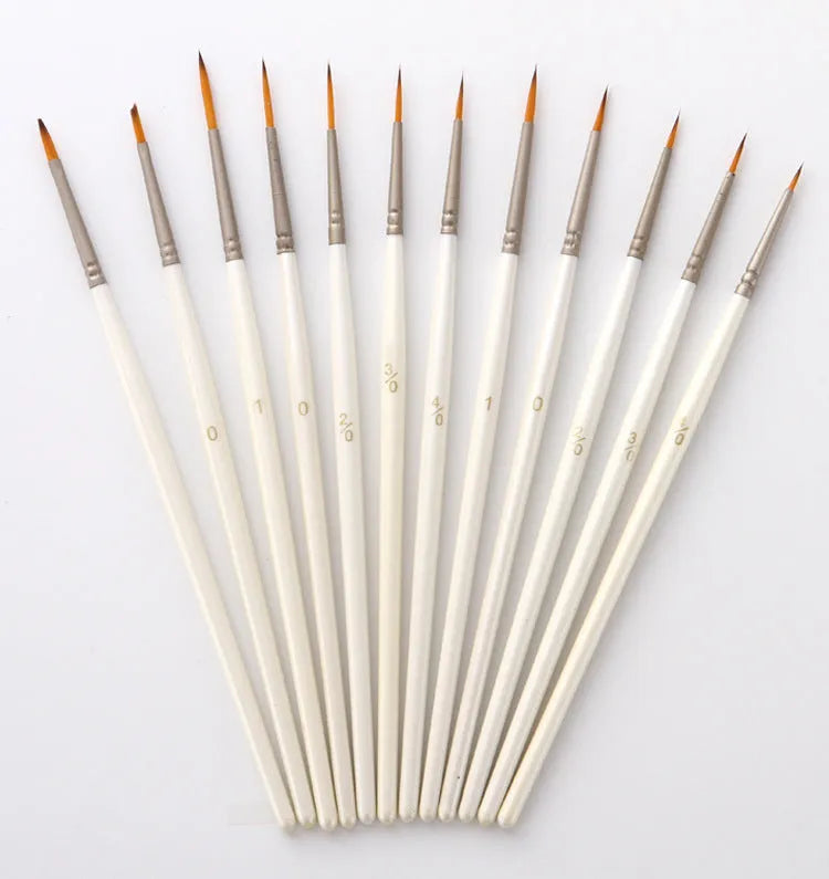 Set of 12 pearl white artist painting brushes with wooden handles and nylon wool fibres.