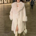 Woman wearing a thick grey faux rabbit fur mid-length coat with a fur collar.