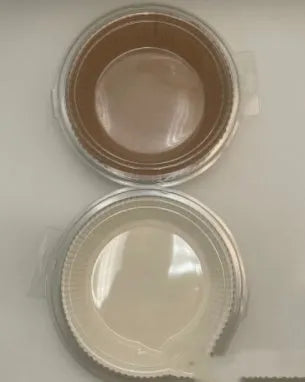 Round white disposable parchment paper liner for air fryer basket with raised edges.