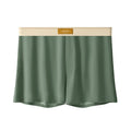 Pack of three men's solid colour ice silk boxer shorts laid flat.