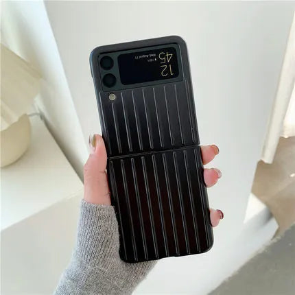 Ultra-thin black flip phone case for Samsung Z Flip3 folding mobile on a table.