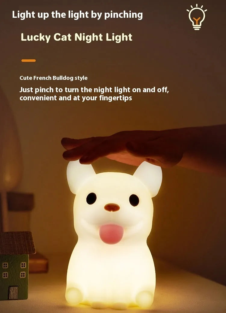 Silicone animal-shaped USB night light with touch dimming on a bedside table.