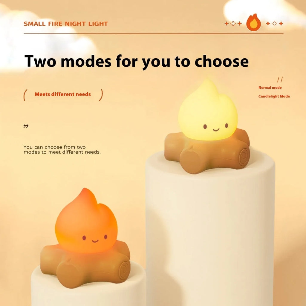 Small yellow silicone night lamp with cartoon fire pile design on a table.