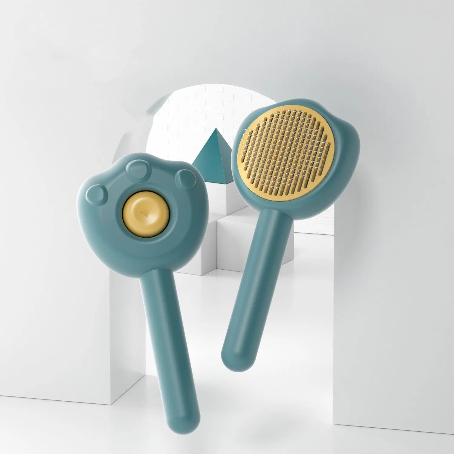 Blue plastic cat grooming comb with retractable needle teeth and a cute handle on a white background