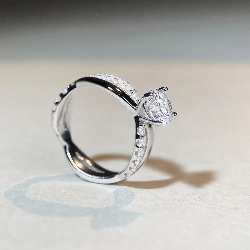 Geometric twist arm silver ring with 1 karat moissanite stone in four-claw winding setting