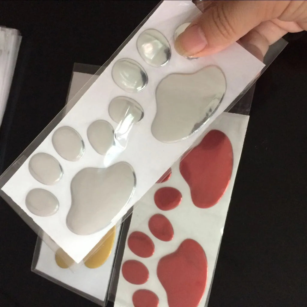 PVC car sticker with hand-shaped brush design showing dog footprint pattern in choice of colours