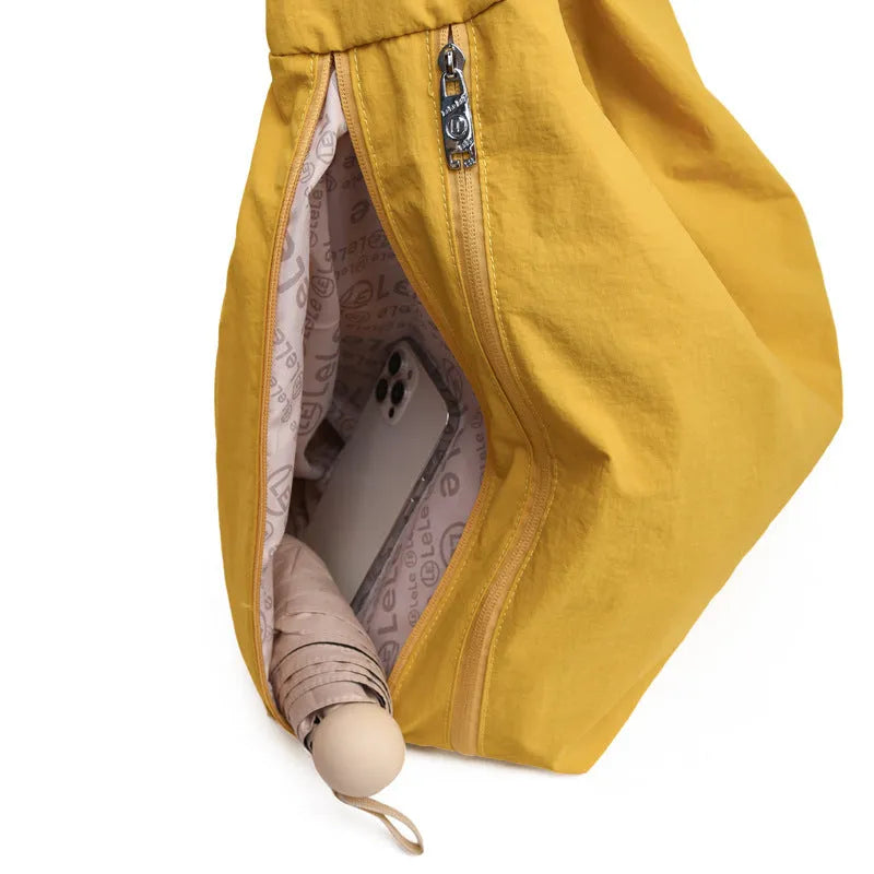 Soft nylon women's underarm bag in heart shape, shown in black, yellow, khaki, or blue.