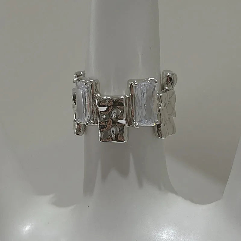 Silver geometric open ring with cross design and zircon centrepiece