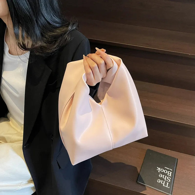 Women's PU leather dumpling-shaped handbag in multiple colours with folding stitch details measuring 24x10x21cm
