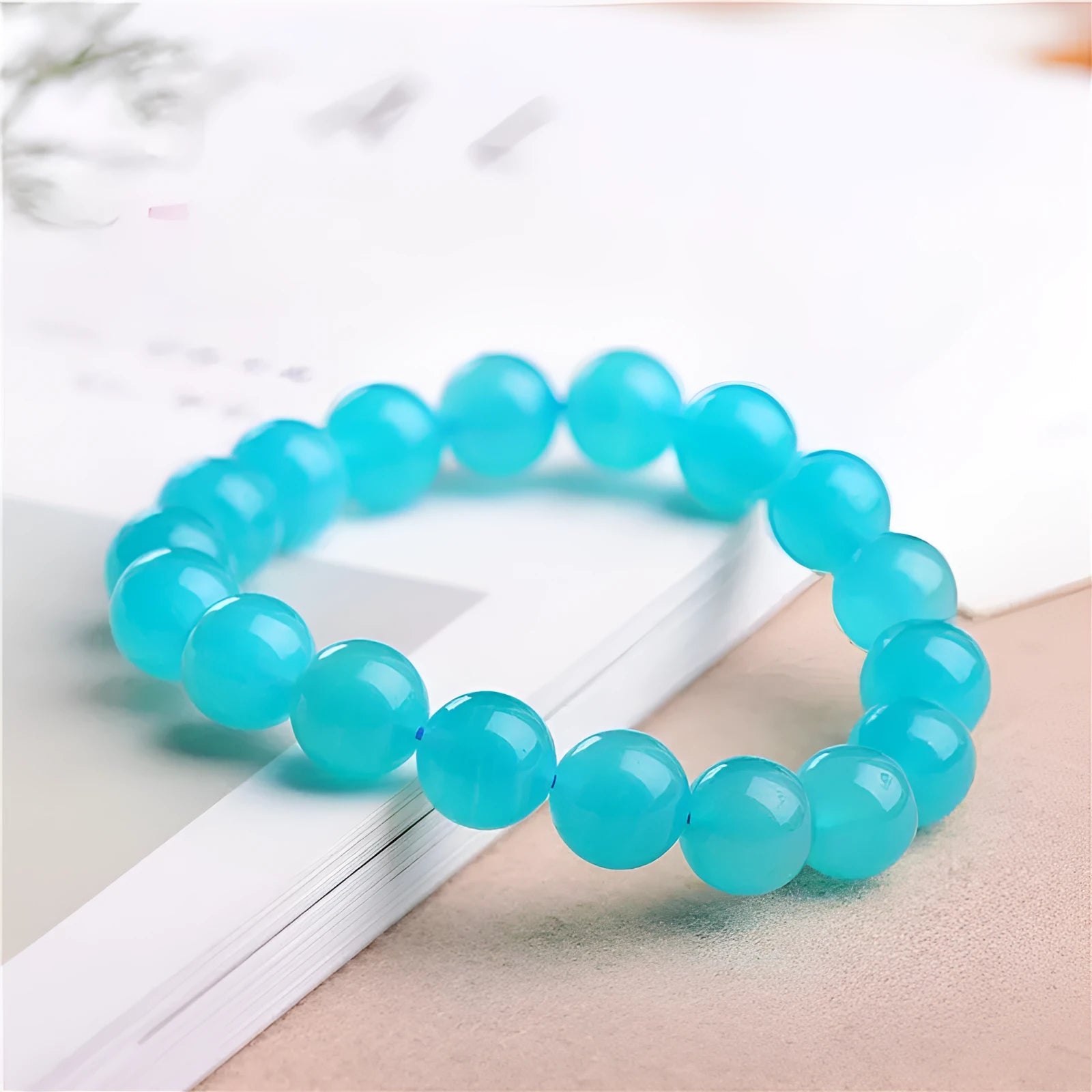Natural blue-green Amazonite 7A grade scattered beads bracelet on a white background.