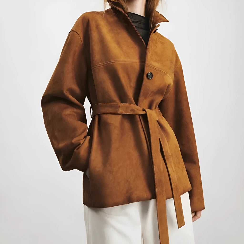 Yellow brown women's mid-length cashmere coat with Peter Pan collar and leather belt on a hanger.