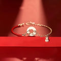 Festive koi bracelet with fishtail design and peace buckle closure on red rope
