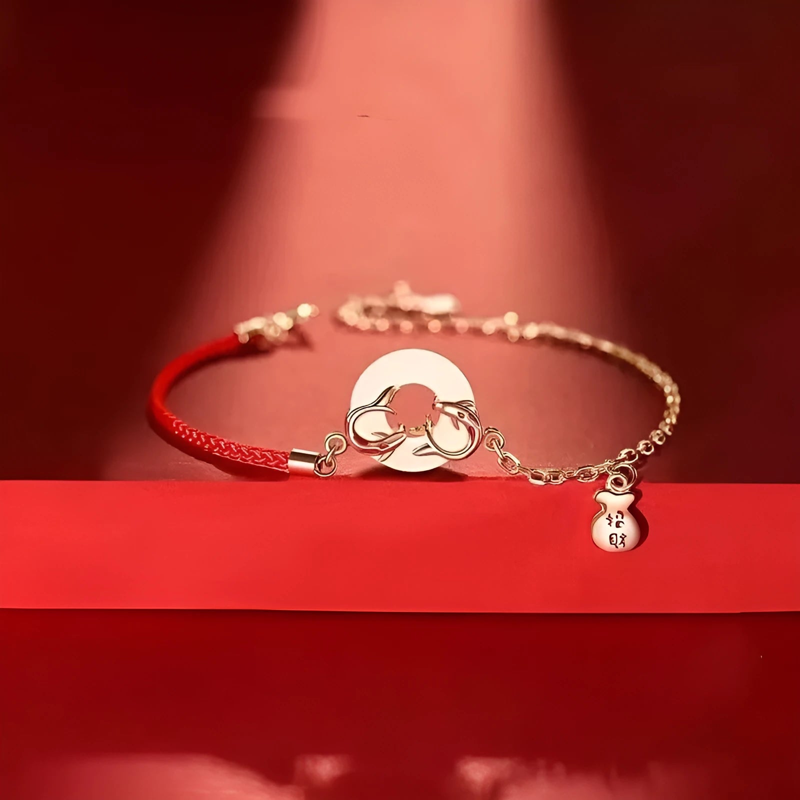 Festive koi bracelet with fishtail design and peace buckle closure on red rope