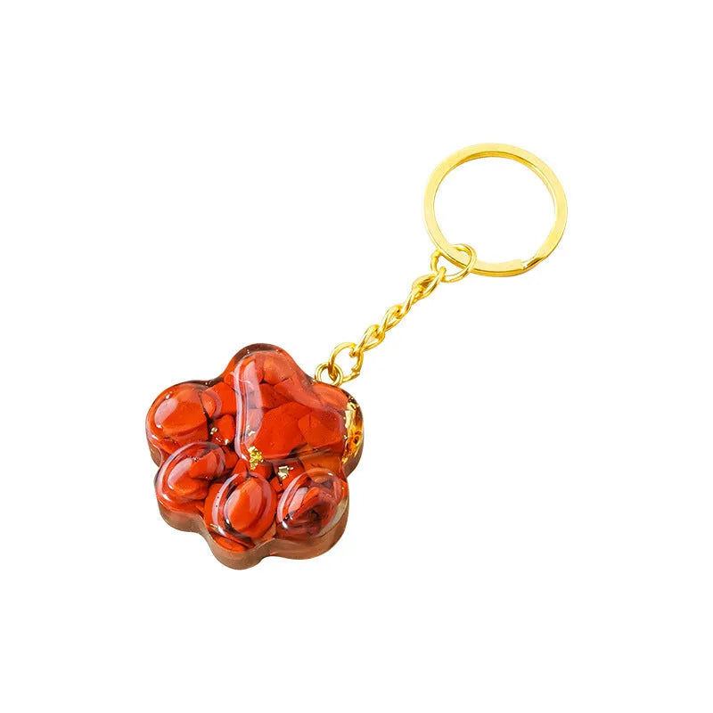 Natural crystal cat's paw keychain pendant on a keyring, colour varies by random gemstone type.