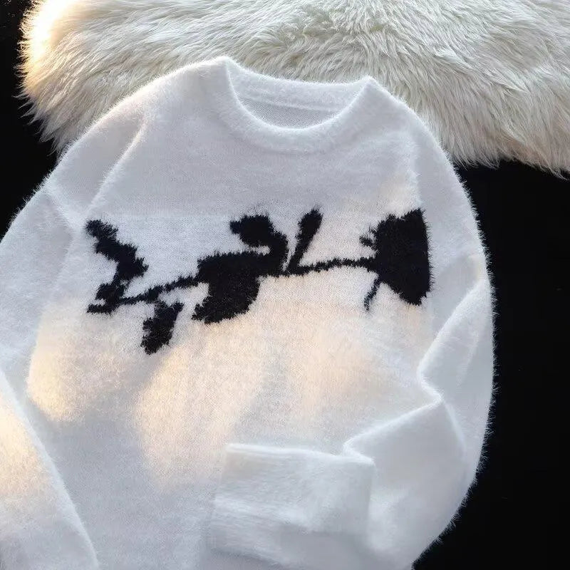 Man wearing a black cotton fleece sweater with a flocking horse and American Dark Rose pattern.