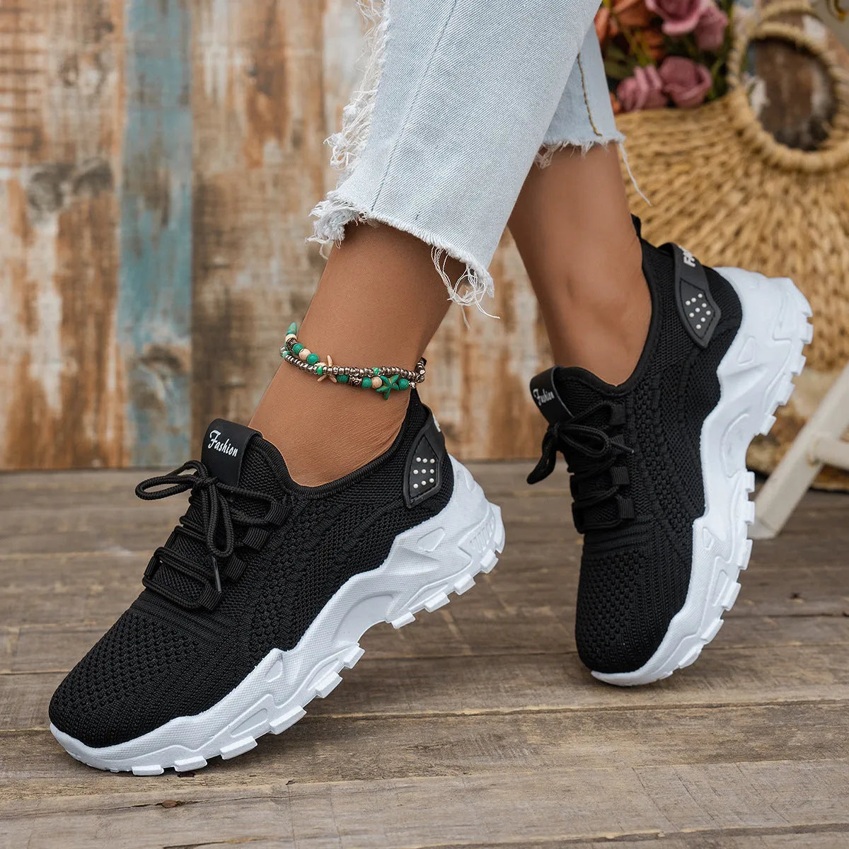 Women's Flyknit mesh casual sports shoes in a flat heel style with a lace-up front.