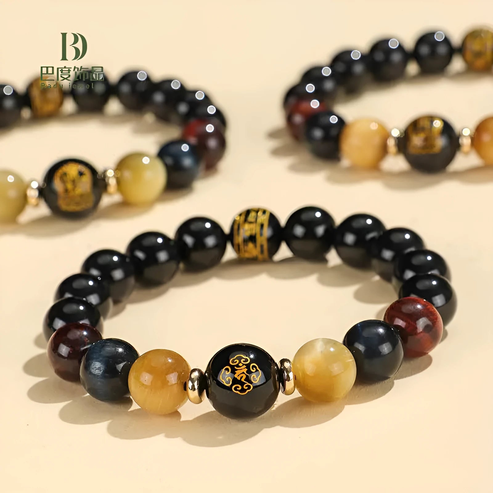 Black agate beaded bracelet with carved Buddhist charm and tiger eye stones