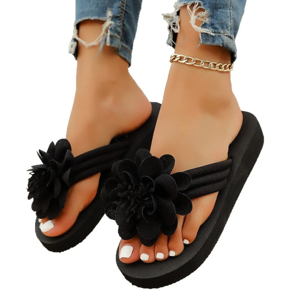 Solid-colour floral flip-flops with a lightweight EVA sole on a plain background.