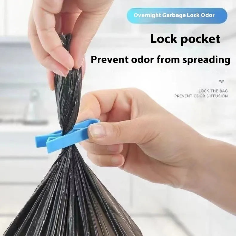 Green and black non-slip plastic clip for holding a bin bag on a wheelie bin rim.