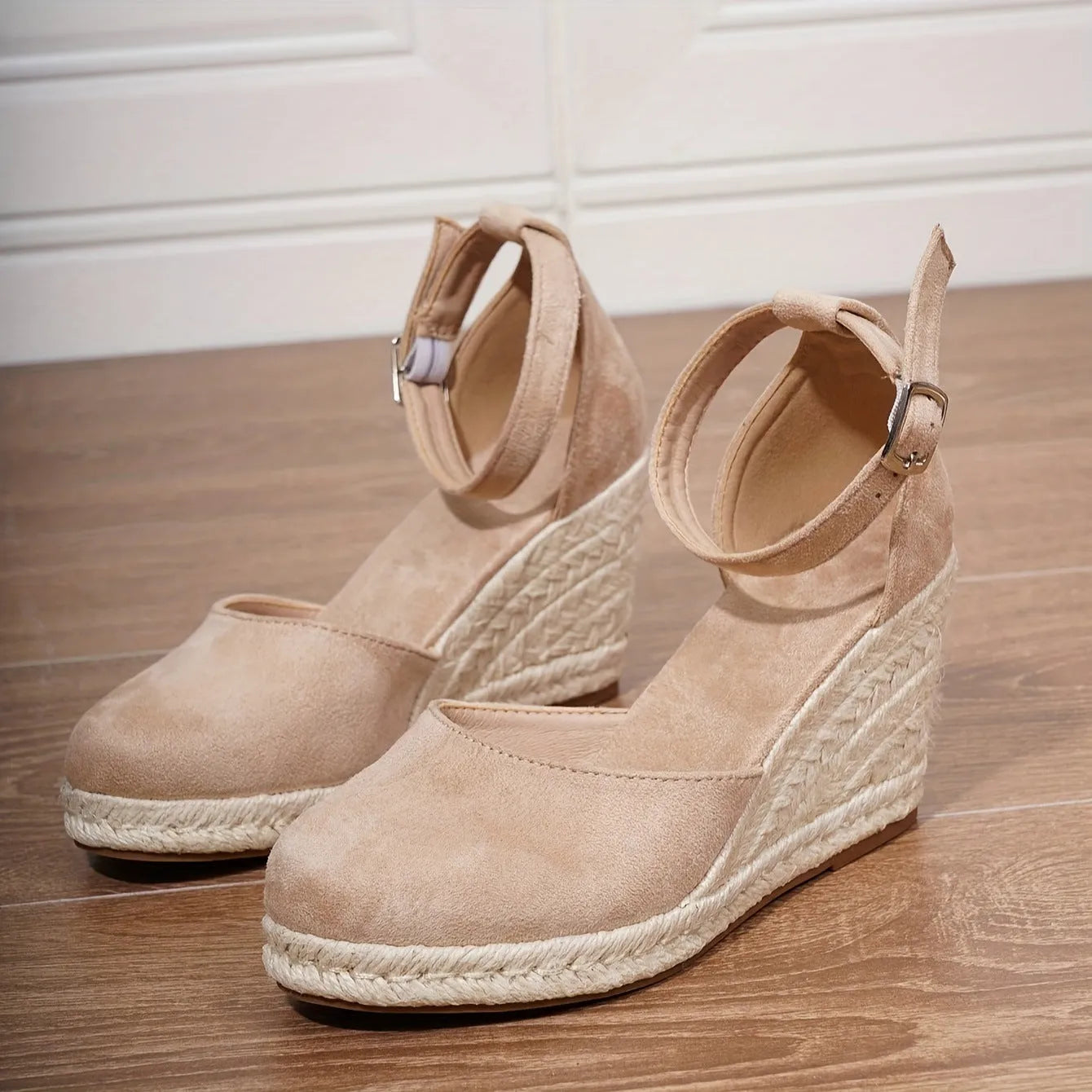 Women's apricot suede wedge sandals with a round toe and buckle strap on a rubber sole.