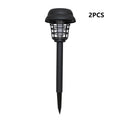 Small white and purple solar-powered mosquito killer lamp for outdoor garden use.
