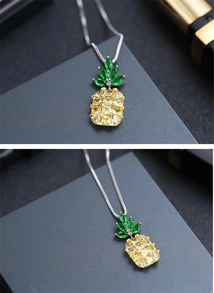 Silver geometric pineapple and diamond pendant necklace on a model.