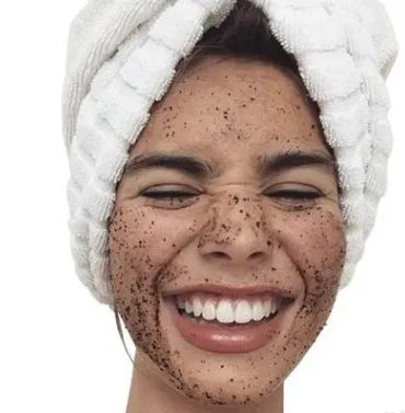 Coconut oil coffee scrub in a jar with natural exfoliating granules for deep cleansing and cellulite reduction