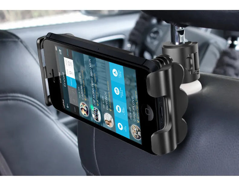 Black car headrest mount holding a tablet on the back seat, showing adjustable arm and universal bracket.