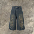 Men's black cropped denim shorts with patch flame embroidery on leg