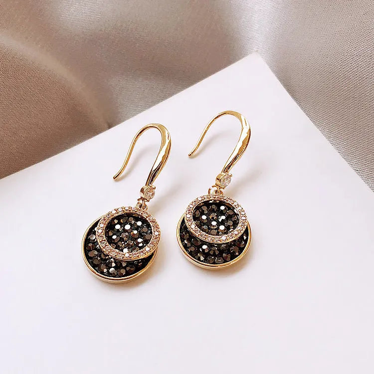 Black geometric alloy earrings with round piece shape measuring 3.6cm in length.
