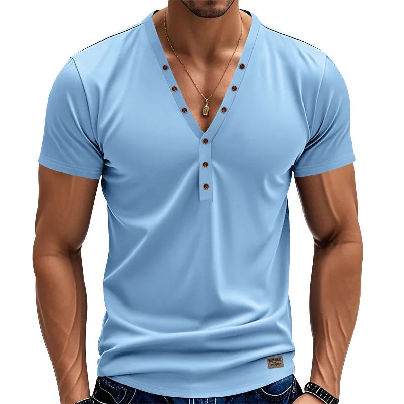 Man wearing a loose fit light blue V-neck pullover top with a button detail.