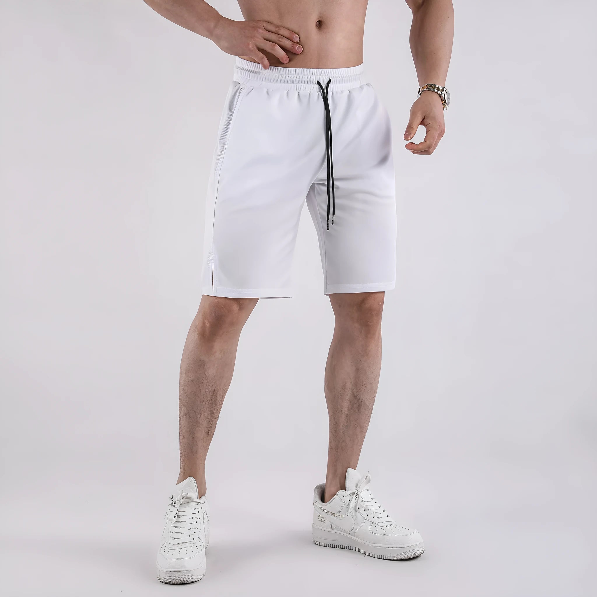 Men's black quick-drying mesh fitness shorts with an elastic waistband, shown in a loose, capri-length style.