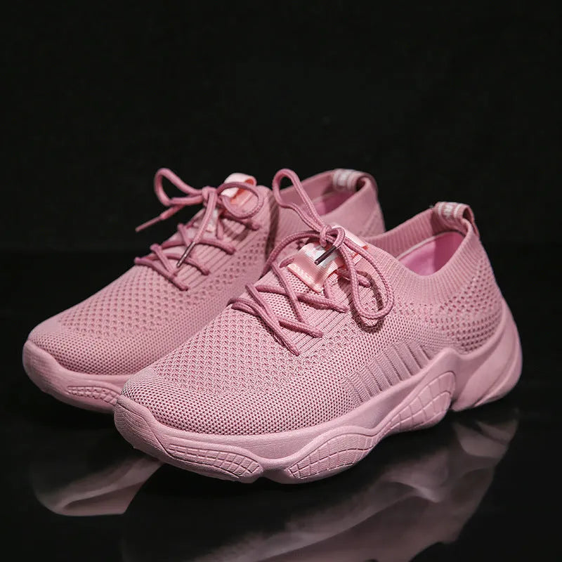 Women's white thick-soled woven sports shoes with front strap on a light background.